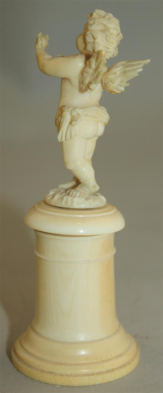 A pair of late 19th / early 20th century European carved ivory figures of winged cherubs, 4.25in. some damage